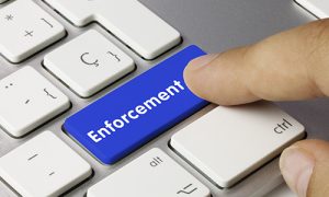 Keyboard blue button that reads "Enforcement"